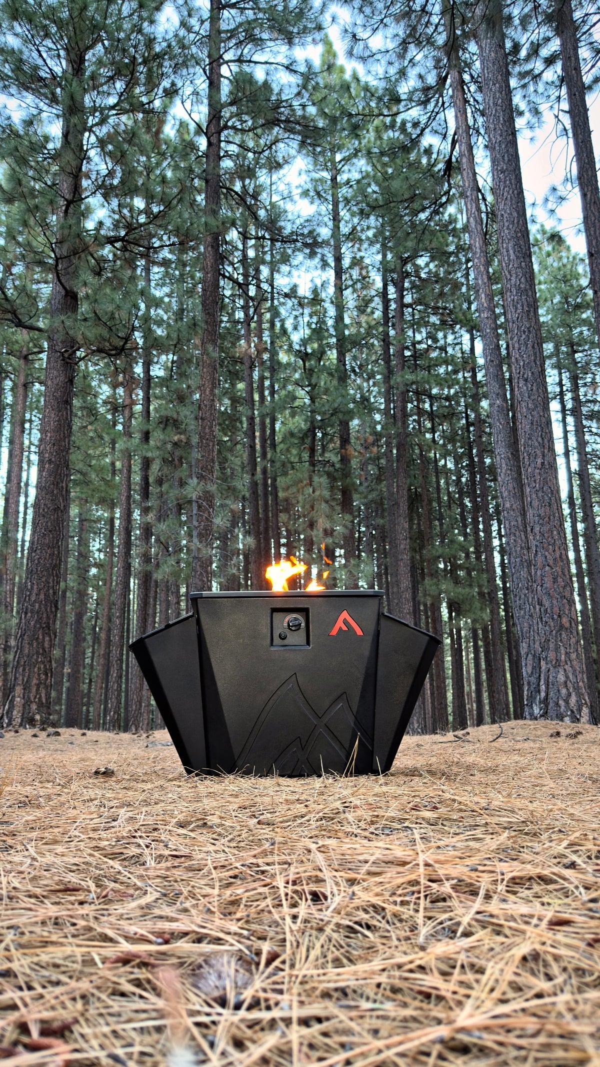 Floating Flame fire pit lit in a pine forest near Lake Tahoe