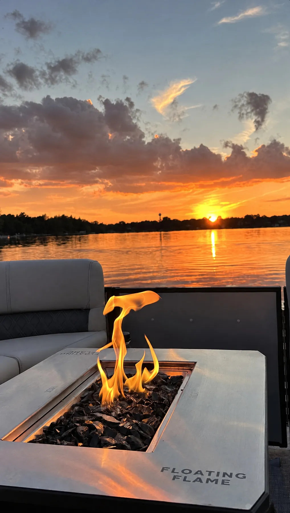 Floating Flame lit on a pontoon deck at sunset