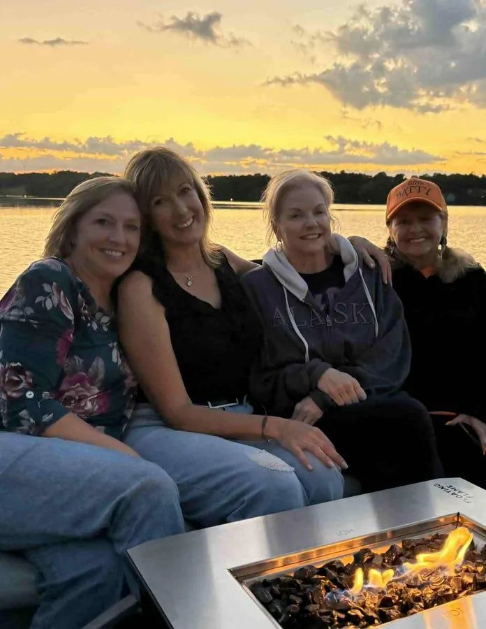 Kim and friends around the fire at sunset
