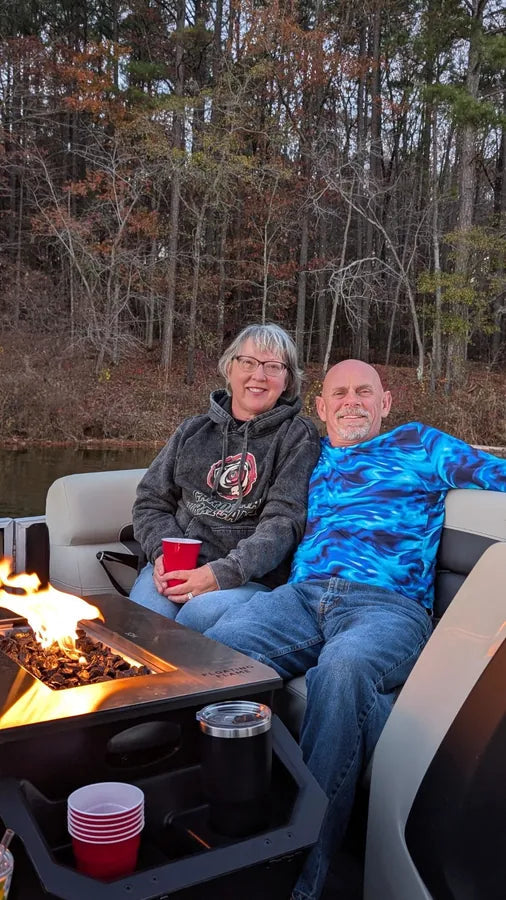 Floating Flame lit on Zella B.'s pontoon with two glasses of wine